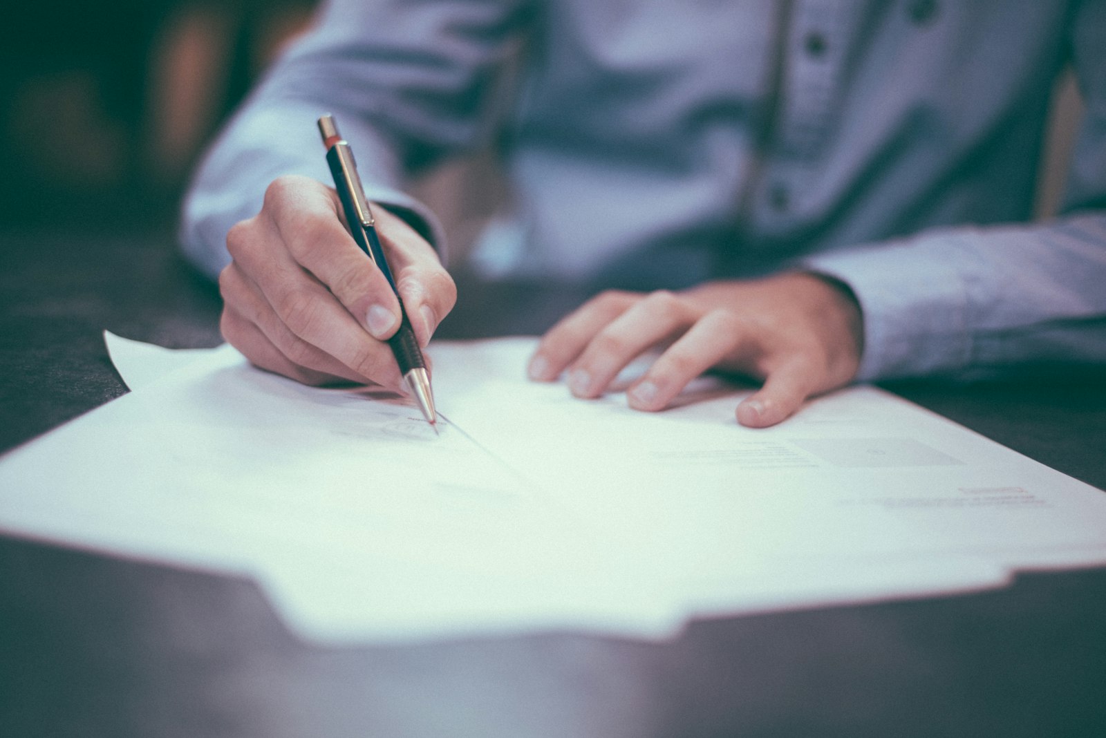 Estate paperwork being prepared beside a cup of coffee
